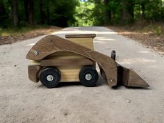 a wooden toy truck on the side of a road