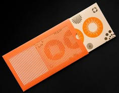 an orange piece of paper with the word go written on it is laying on a black surface