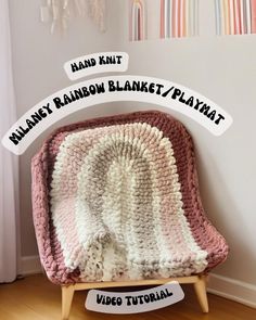 a crocheted blanket sitting on top of a wooden chair next to a wall