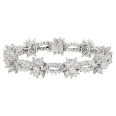 Platinum diamond fashion bracelet featuring snow flake cluster design totaling 23.00 cts of marquise and round diamonds Diana M. is a leading supplier of top-quality fine jewelry for over 35 years. Diana M is one-stop shop for all your jewelry shopping, carrying line of diamond rings, earrings, bracelets, necklaces, and other fine jewelry. We create our jewelry from gemstones and diamonds of the highest quality (GIA certified) as well as the highest quality of gold and platinum to deliver magnif Luxury Diamond White Fine Jewelry Bracelets, Luxury White Gold Diamond Bracelet With Accents, Fine Jewelry Diamond White Diamond Bracelet, Luxury Flower-shaped Fine Jewelry Bracelets, Adjustable White Diamond Bracelet, Fine Jewelry, Snowflake Bracelet, Modern Bracelets, Diamond Fashion, Diamond Bracelets