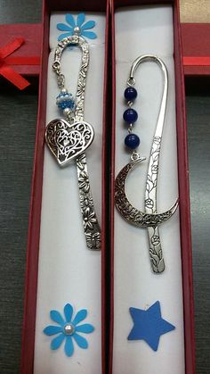 two open boxes with charms in them sitting on a table