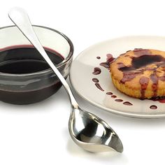 a plate with a pastry on it next to a bowl and spoon