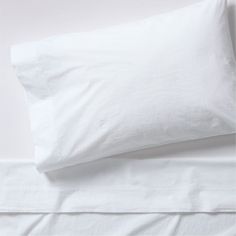 white sheets and pillows on top of each other