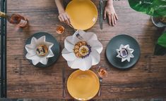 a person sitting at a table with plates and utensils