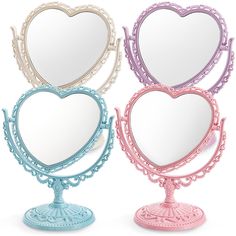 three heart shaped mirrors on top of each other in different colors and sizes, one is pink, the other is blue