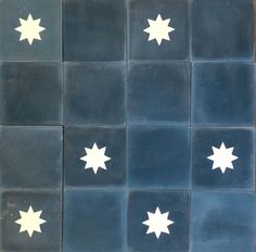 several white stars are arranged on blue tiles