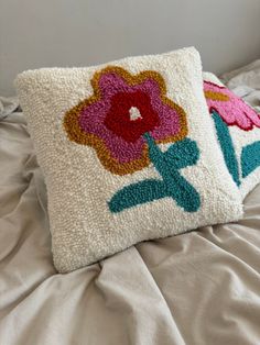 a white pillow with colorful flowers on it