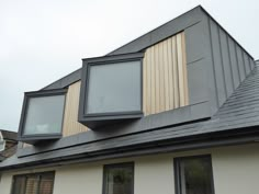 the roof of a house with three windows