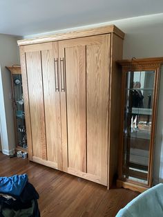 a large wooden cabinet sitting on top of a hard wood floor