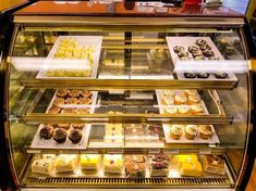 a display case filled with lots of different types of cakes