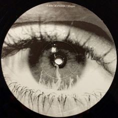 an eye looking into the distance with long lashes on it's iris, in front of a black and white background