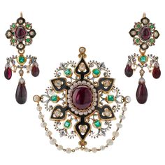 This extravagant French Renaissance Revival "Holbeinesque" demi-parure dating from circa 1870 consists of a day/night girandole pendant earrings and a brooch, both composed of garnets, emeralds, diamonds, seed pearls, enamel and 18K gold. The day/night girandole earpendants are each designed with a shaped top centering a cabochon garnet, with detachable pendants suspending flexibly-set garnet drops and seed pearls, enhanced throughout with step-cut emeralds, old mine-cut diamonds, and black and Hans Holbein, Original Jewelry Design, Jewelry Design Drawing, Seed Pearl, Day Night, British Museum, Metropolitan Museum, Morganite, Pendant Earrings