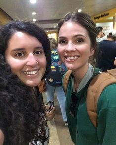 two women standing next to each other smiling