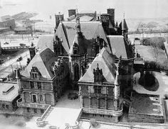 an aerial view of a large building in the middle of winter with snow on the ground