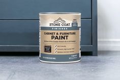 a can of cabinet and furniture paint sitting on the floor next to a blue dresser