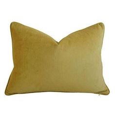 a yellow pillow on a white background