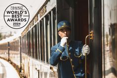 a man in uniform standing next to a train