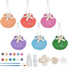 six different colored seashells with white bows on them and other crafting supplies