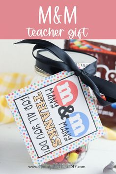 a mason jar filled with m & m teacher gifts