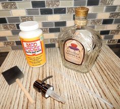 the contents of a bottle of alcohol sitting on top of a counter next to a knife