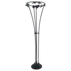 a black metal floor lamp with three birds on it