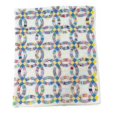 a white quilt with multicolored circles on it