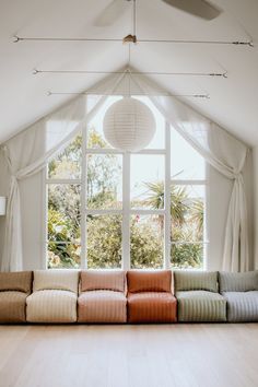 a living room filled with furniture and a large window