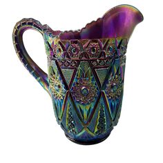 a colorful glass pitcher is shown on a white background