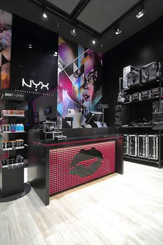 a store display with many different items on the shelves and in front of it is an advertisement for nyx cosmetics