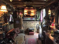 a living room filled with lots of furniture and decor on top of carpeted flooring