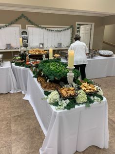 a buffet table with food and candles on it