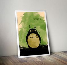 a poster with the character totoro on it's face in front of a wall