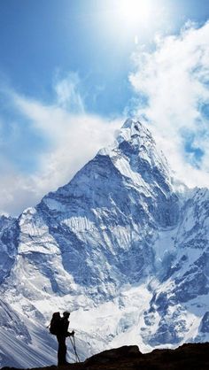 a person standing on top of a snow covered mountain