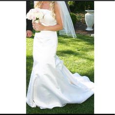 a woman in a wedding dress holding a bouquet