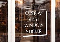 a window with the words custom vinyl window sticker written in white letters on it