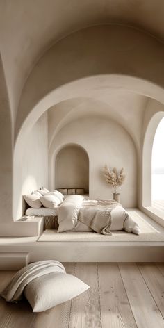 a large bed sitting in the middle of a bedroom next to a window with an arch