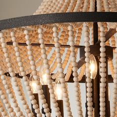 a chandelier with wooden beads hanging from it