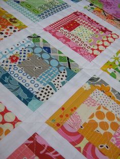 a colorful quilt with many different designs on it