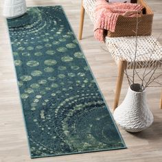 a blue rug with an intricate design on the floor next to a chair and table