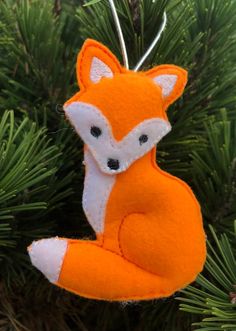 an ornament shaped like a fox hanging from a tree