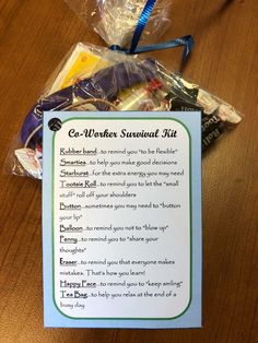 a wooden table topped with a bag of candy and a sign that says e - winter survival kit