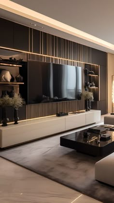 a modern living room with black and white furniture in the center, large television on wall