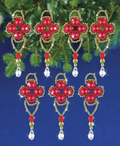 christmas ornaments hanging from a tree with red beads and crystal drops on it's sides