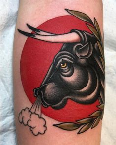 a bull with horns on its head is spraying water from it's mouth in front of a red sun