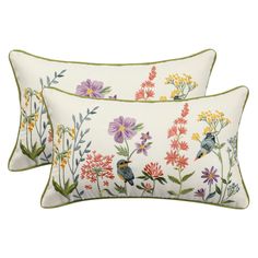 two pillows with colorful flowers and birds on them