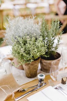 the table is set with silverware and place settings