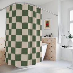 a green and white checkered shower curtain in a bathroom with a bathtub next to it