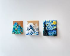 three small pieces of beaded art hanging on a white wall next to each other