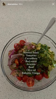 a glass bowl filled with salad on top of a table