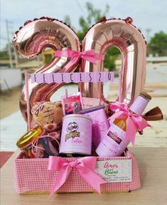 a pink gift box filled with balloons and gifts for someone's 30th birthday or other special occasion